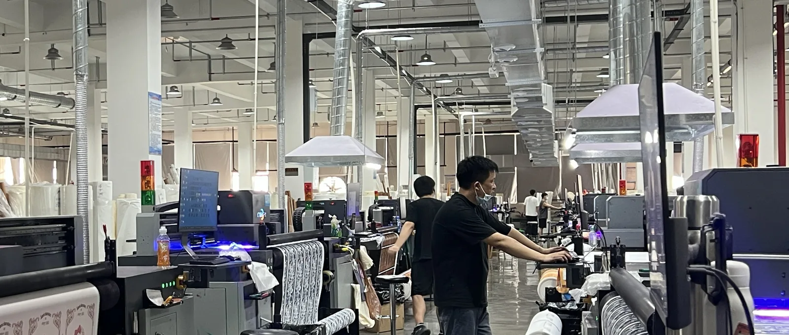 Heat-transfer printing line applying custom artwork to canvas fabric